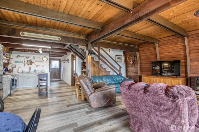 568 Cowlitz Ct SW, Ocean Shores, WA 98569 - living room with stairway, light wood-type flooring, wooden walls, a bar, and wooden ceiling with exposed beams