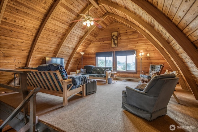 568 Cowlitz Ct SW, Ocean Shores, WA 98569 - living room with wooden walls, wooden ceiling, carpet, a ceiling fan, and a baseboard radiator