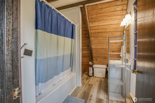 568 Cowlitz Ct SW, Ocean Shores, WA 98569 - bathroom featuring wood finished floors, shower / bathtub combination with curtain, and wood walls