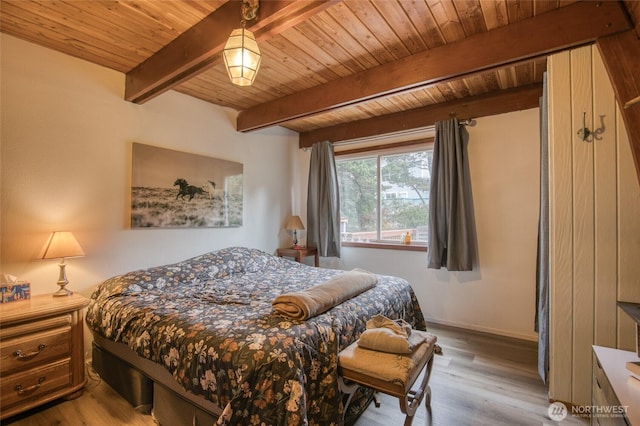 568 Cowlitz Ct SW, Ocean Shores, WA 98569 - bedroom featuring wooden ceiling with exposed beams, wood finished floors, and baseboards