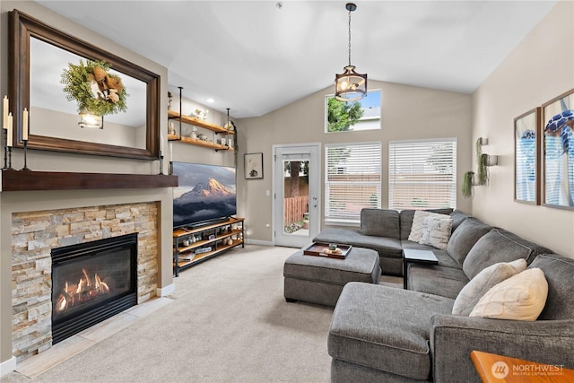 1317 60th St SE Unit A, Auburn, WA 98092 - living room featuring vaulted ceiling, a stone fireplace, carpet flooring, and baseboards