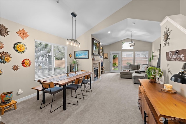 1317 60th St SE Unit A, Auburn, WA 98092 - dining area featuring vaulted ceiling, light colored carpet, a fireplace with flush hearth, and baseboards