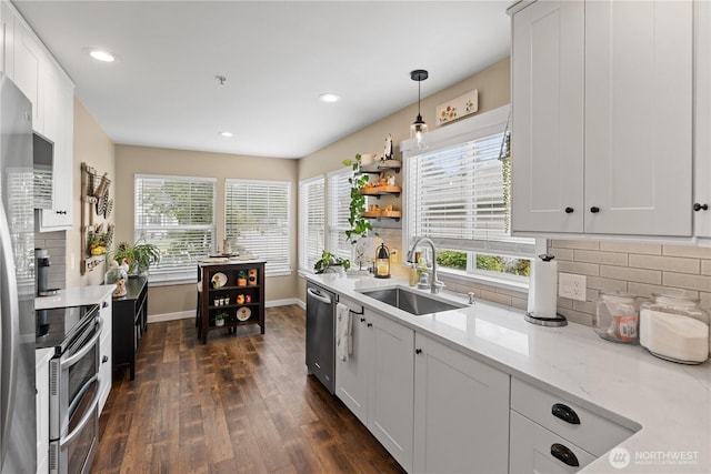 1317 60th St SE Unit A, Auburn, WA 98092 - kitchen featuring stainless steel appliances, a sink, plenty of natural light, dark wood-style flooring, and recessed lighting