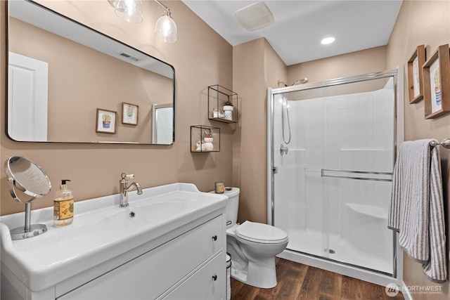 1317 60th St SE Unit A, Auburn, WA 98092 - bathroom featuring a shower stall, toilet, vanity, and wood finished floors