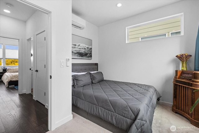 6055 7th Ave NW, Seattle, WA 98107 - bedroom featuring a wall mounted AC, multiple windows, wood finished floors, recessed lighting, and baseboards