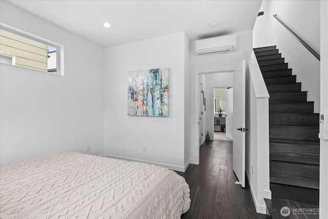 6055 7th Ave NW, Seattle, WA 98107 - bedroom featuring a wall mounted air conditioner, dark wood-type flooring, baseboards, and recessed lighting