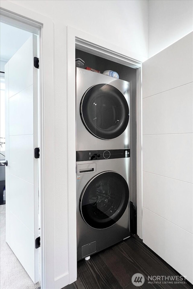 6055 7th Ave NW, Seattle, WA 98107 - laundry area with stacked washer / dryer and dark carpet