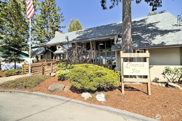 201 E Sleaford Rd, Shelton, WA 98584 - view of front of house featuring roof with shingles and a balcony