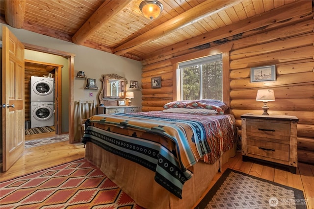 21 Oakes Dr, Tonasket, WA 98855 - bedroom featuring stacked washer / drying machine, a wood ceiling with exposed beams, rustic walls, and light wood finished floors