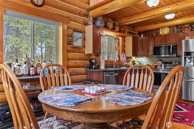 21 Oakes Dr, Tonasket, WA 98855 - dining area with log walls, plenty of natural light, and a wood ceiling with exposed beams