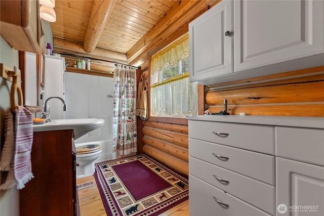 21 Oakes Dr, Tonasket, WA 98855 - full bathroom with rustic walls, a wooden ceiling with exposed beams, vanity, shower / bath combo with shower curtain, and wood-type flooring