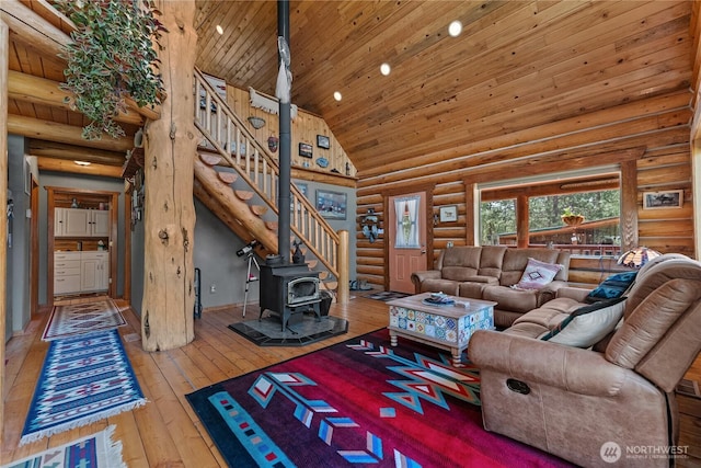 21 Oakes Dr, Tonasket, WA 98855 - living room featuring rustic walls, a wood stove, high vaulted ceiling, wooden ceiling, and wood-type flooring