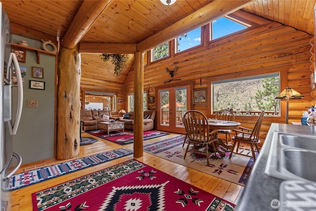 21 Oakes Dr, Tonasket, WA 98855 - dining room featuring rustic walls, high vaulted ceiling, a wood ceiling with exposed beams, hardwood / wood-style floors, and french doors