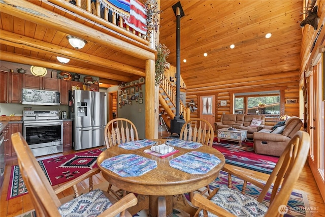 21 Oakes Dr, Tonasket, WA 98855 - dining space with rustic walls, light wood-style floors, wooden ceiling, stairs, and recessed lighting