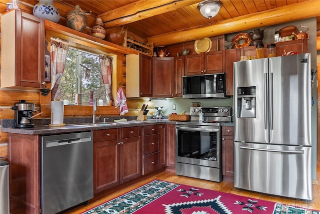 21 Oakes Dr, Tonasket, WA 98855 - kitchen with stainless steel appliances, a wooden ceiling with exposed beams, light wood-style floors, and dark countertops