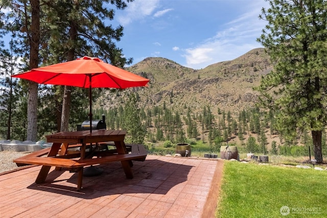 21 Oakes Dr, Tonasket, WA 98855 - view of patio with a mountain view, outdoor dining area, and a wooded view