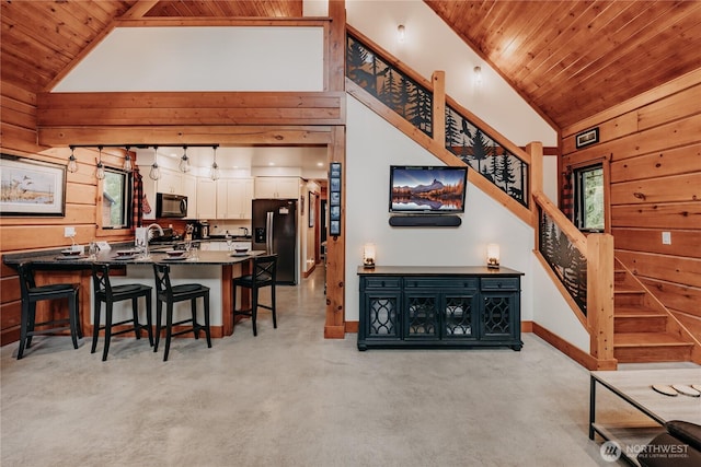 15033 Welcome Rd, Glacier, WA 98244 - dining area with wood ceiling, wooden walls, stairs, baseboards, and high vaulted ceiling