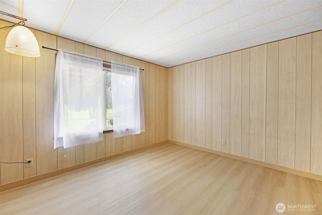 1405 226th St NW, Silvana, WA 98287 - spare room with wood finished floors, a textured ceiling, and wooden walls