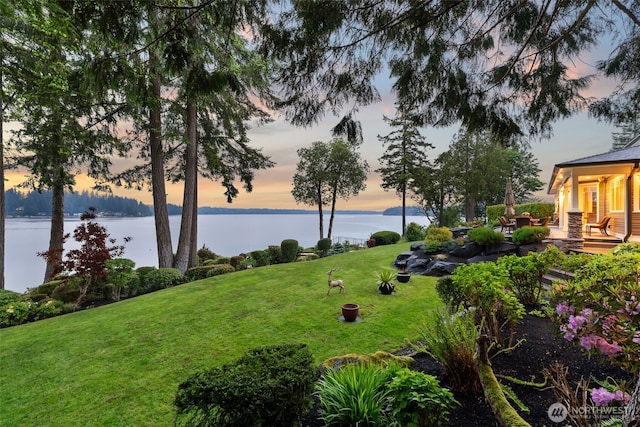 4825 Bayshore Ln NW, Olympia, WA 98502 - yard at dusk featuring a water view and a lawn