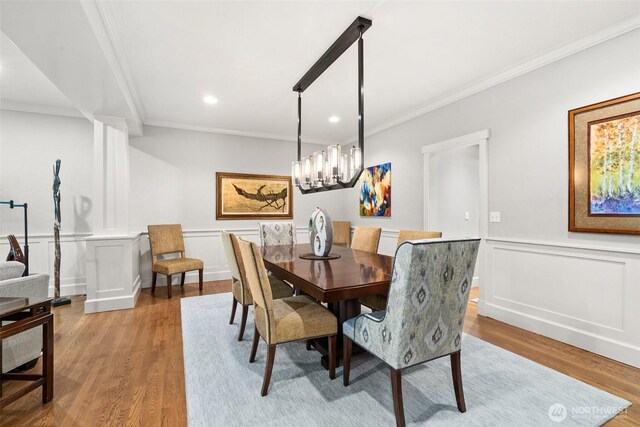 4825 Bayshore Ln NW, Olympia, WA 98502 - dining room featuring ornamental molding, wood finished floors, recessed lighting, a decorative wall, and wainscoting
