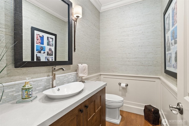 4825 Bayshore Ln NW, Olympia, WA 98502 - half bathroom with vanity, toilet, wood finished floors, wainscoting, and crown molding