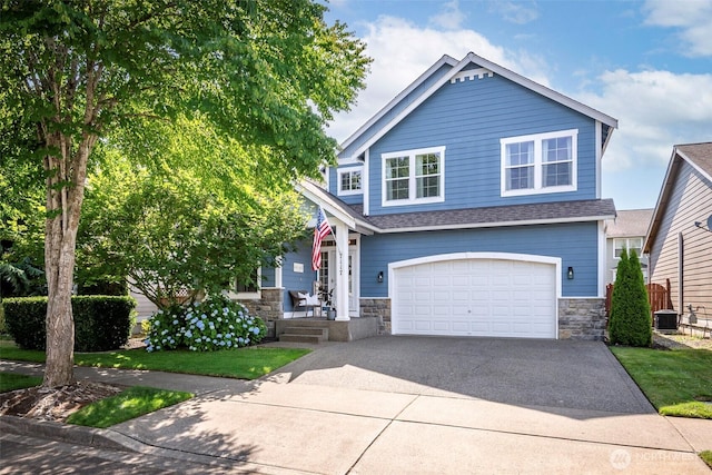 7117 Axis St SE, Lacey, WA 98513 - view of front of home with stone siding, a garage, concrete driveway, and roof with shingles