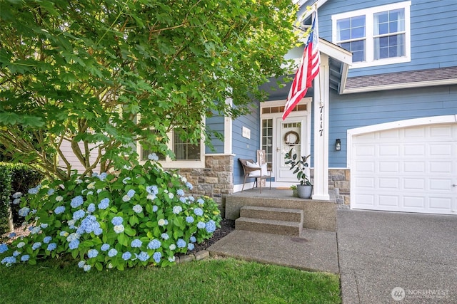 7117 Axis St SE, Lacey, WA 98513 - doorway to property with a garage, stone siding, and roof with shingles