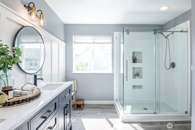 7117 Axis St SE, Lacey, WA 98513 - bathroom with double vanity, wood finished floors, a shower stall, and recessed lighting