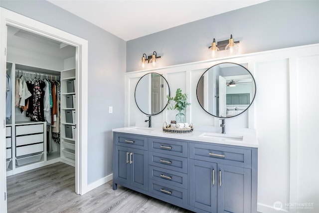 7117 Axis St SE, Lacey, WA 98513 - full bath with double vanity, wood finished floors, ceiling fan, and a spacious closet