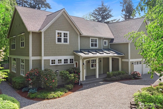 301 Weaver Rd NW, Bainbridge Island, WA 98110 - view of front of property featuring a garage, a porch, a shingled roof, and driveway