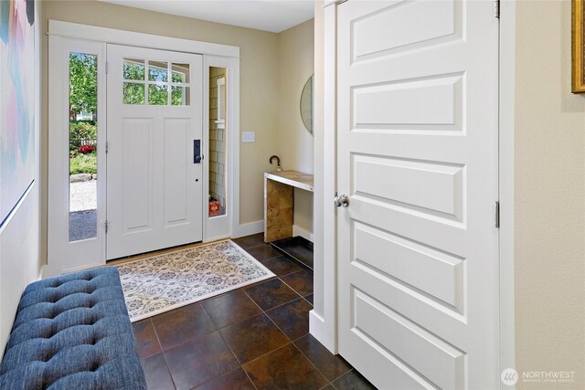 301 Weaver Rd NW, Bainbridge Island, WA 98110 - foyer entrance with baseboards and dark tile patterned floors