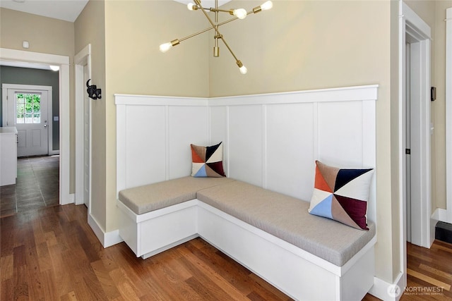 301 Weaver Rd NW, Bainbridge Island, WA 98110 - corridor with a chandelier, wood finished floors, a decorative wall, and a wainscoted wall