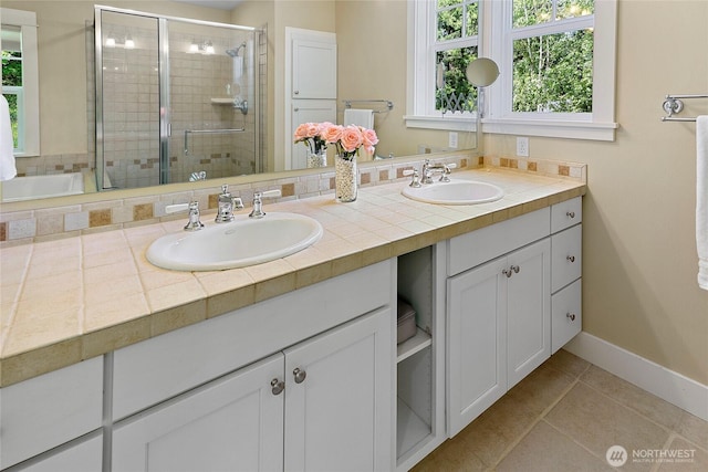 301 Weaver Rd NW, Bainbridge Island, WA 98110 - full bath with a shower stall, double vanity, baseboards, and tile patterned floors