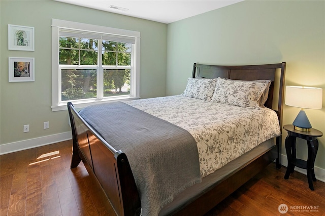301 Weaver Rd NW, Bainbridge Island, WA 98110 - bedroom featuring baseboards and dark wood-type flooring