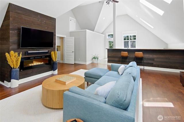 301 Weaver Rd NW, Bainbridge Island, WA 98110 - living area with a skylight, vaulted ceiling, a ceiling fan, wood finished floors, and baseboards