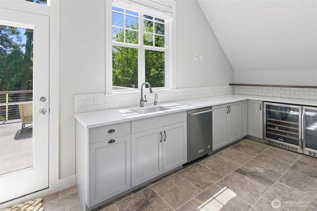 301 Weaver Rd NW, Bainbridge Island, WA 98110 - kitchen featuring beverage cooler, dishwasher, vaulted ceiling, plenty of natural light, and tasteful backsplash
