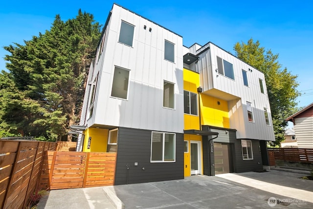 725 18th Ave Unit A, Seattle, WA 98122 - modern home with board and batten siding, driveway, and an attached garage