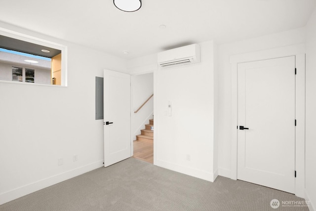 725 18th Ave Unit A, Seattle, WA 98122 - unfurnished bedroom with a wall unit AC, carpet, baseboards, and electric panel