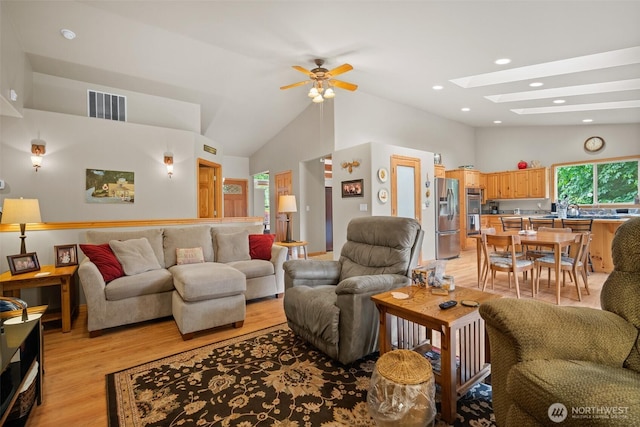 23405 Jordan Rd, Arlington, WA 98223 - living room with a skylight, light wood-style floors, ceiling fan, high vaulted ceiling, and recessed lighting