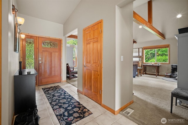 23405 Jordan Rd, Arlington, WA 98223 - entryway featuring a wood stove, healthy amount of natural light, high vaulted ceiling, light tile patterned floors, and baseboards