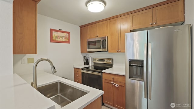 28311 18th Ave S Unit A102, Federal Way, WA 98003 - kitchen with appliances with stainless steel finishes, a sink, light countertops, and brown cabinetry