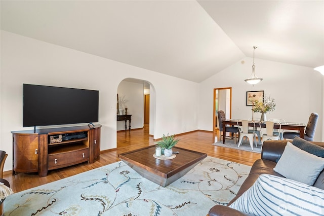 4239 Northridge Way, Bellingham, WA 98226 - living room with lofted ceiling, arched walkways, light wood-style floors, and baseboards