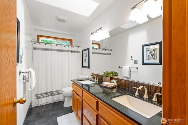 4239 Northridge Way, Bellingham, WA 98226 - bathroom featuring toilet, double vanity, a shower with shower curtain, and decorative backsplash