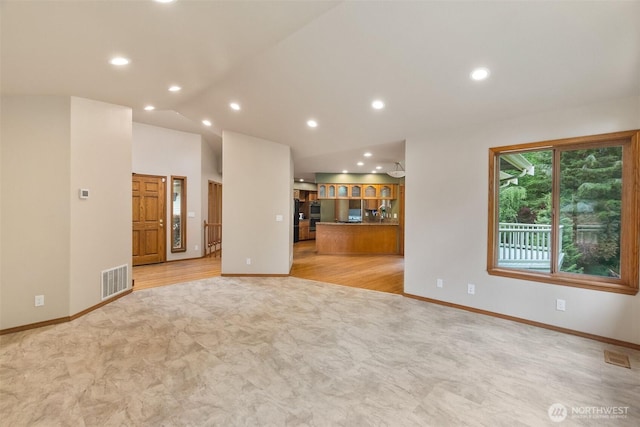 434 N 8th St, Montesano, WA 98563 - unfurnished living room featuring recessed lighting, lofted ceiling, baseboards, and light wood-style flooring