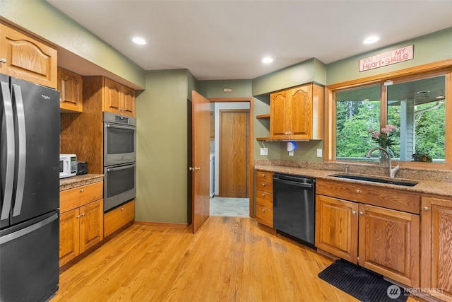 434 N 8th St, Montesano, WA 98563 - kitchen featuring appliances with stainless steel finishes, a sink, light wood finished floors, brown cabinetry, and recessed lighting