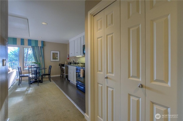 1917 Rosario Rd Unit 2104, Orcas Island, WA 98245 - kitchen featuring stove, light carpet, white cabinets, and recessed lighting
