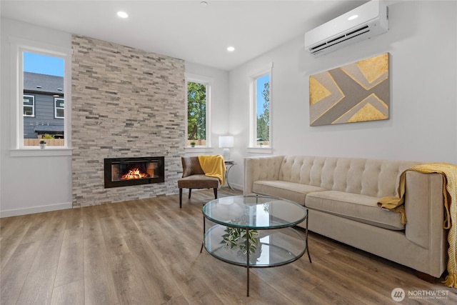 2617 Spruce Rd Unit A, Lake Stevens, WA 98258 - living area featuring a wall mounted air conditioner, wood finished floors, a fireplace, baseboards, and recessed lighting