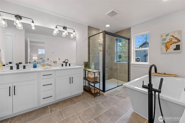 2617 Spruce Rd Unit A, Lake Stevens, WA 98258 - bathroom with double vanity, a stall shower, a freestanding tub, and recessed lighting