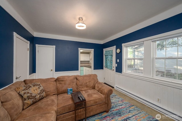 18226 Road B NW, Ephrata, WA 98823 - living room featuring a baseboard radiator, a wainscoted wall, and healthy amount of natural light