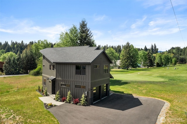 141 Pebble Beach Dr, Cle Elum, WA 98922 - view of home's exterior featuring board and batten siding, driveway, a yard, and a shingled roof